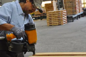 Pallet recycling and repair by a warehouse worker