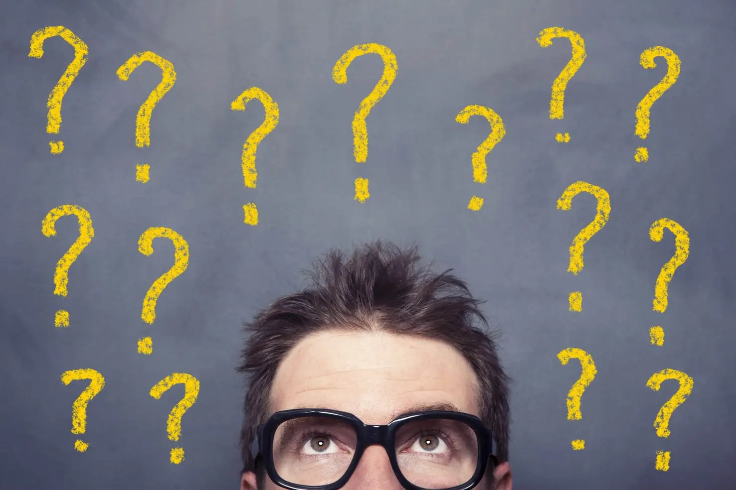 Man's head with question marks. THE FOUR STRESSFUL “UNS” – Uncertain, Unclear, Unknown, Unexpected