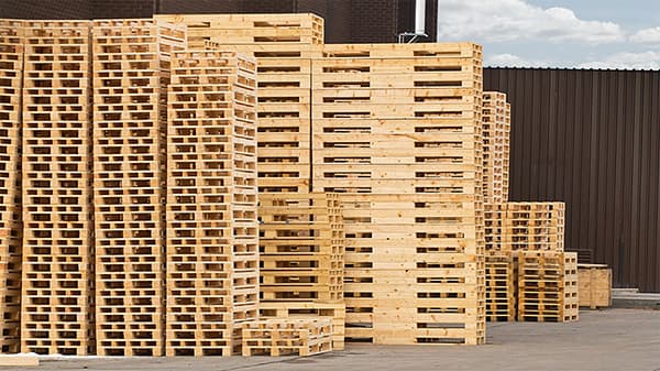 wooden skids stacked like pallets in a pallet warehouse
