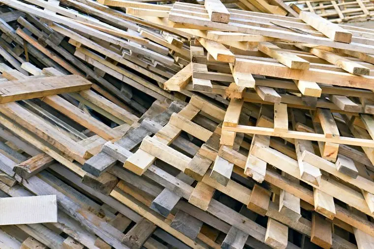 Piled into a heap of wooden pallets