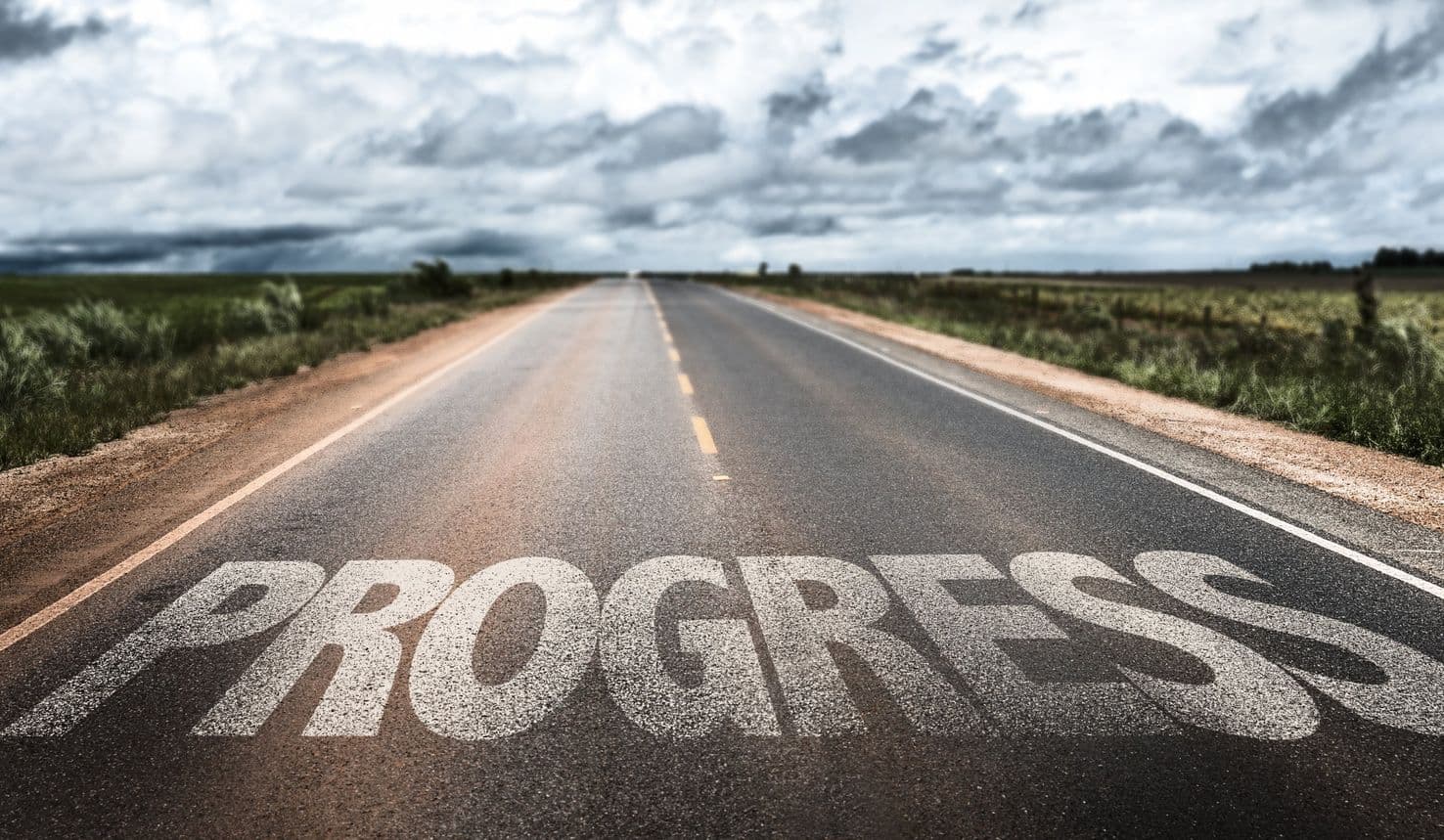 Progress written on rural road