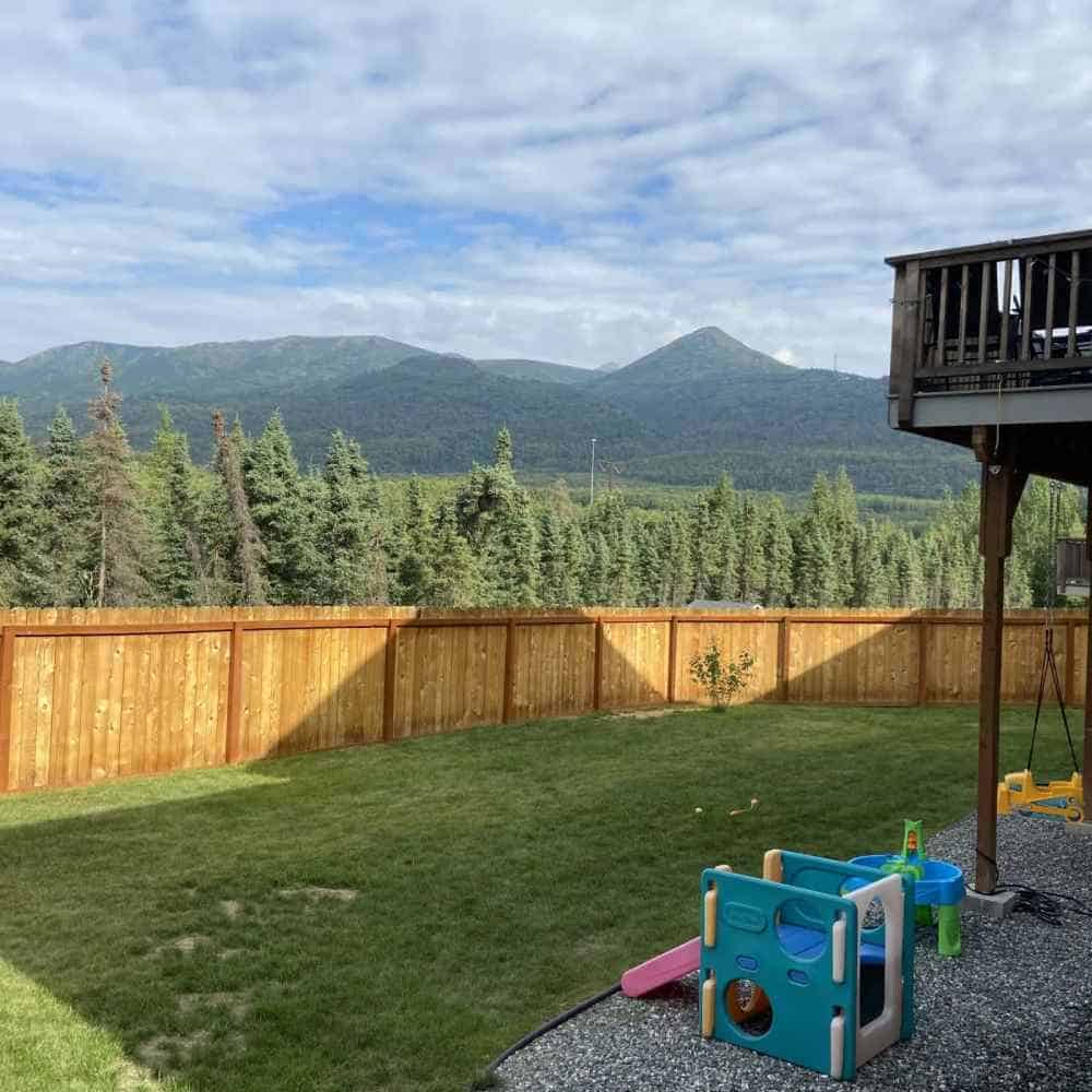 Beautiful backyard with mountain scenery and a safe play zone for kids.