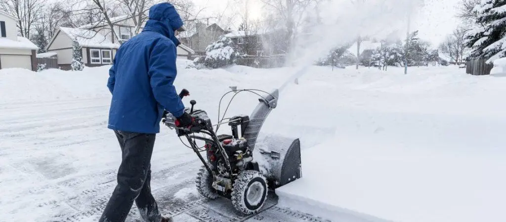 Clear snow with a snowblower in a residential area during winter.