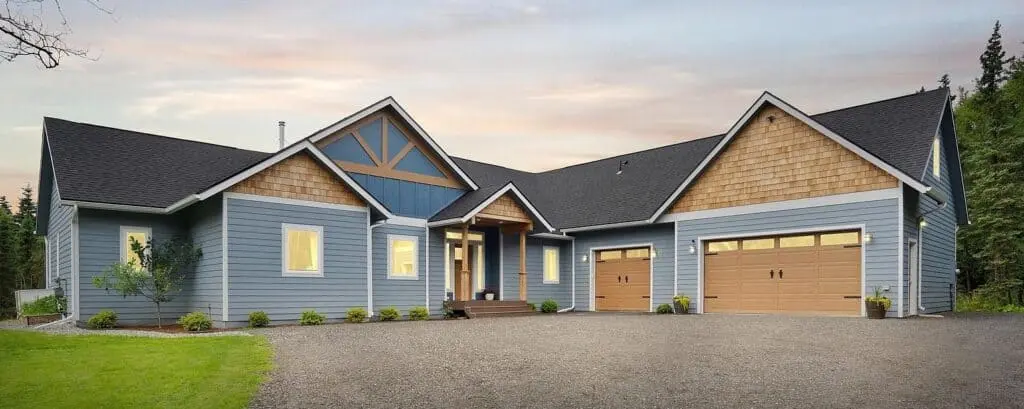 A comfortable modern house with blue siding and a spacious driveway, showcasing Be Happy Property Se.