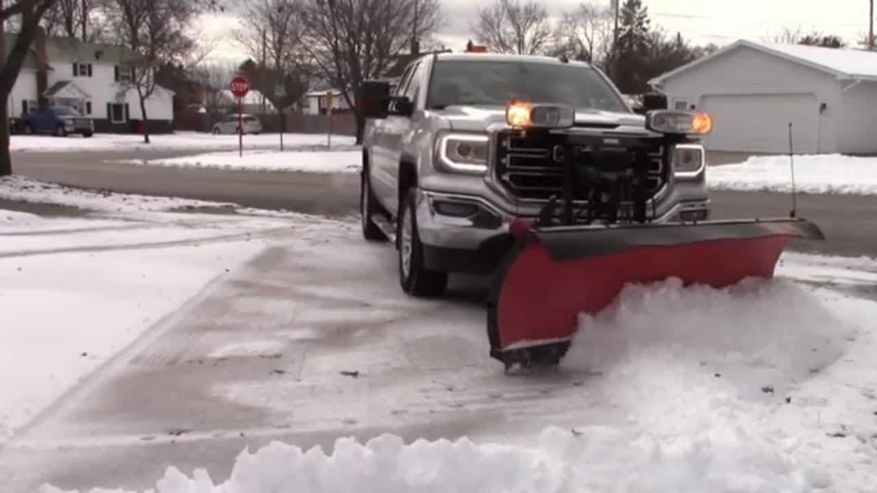 Be Happy plow truck clearing a residential driveway in Anchorage