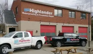Highlander Waterproofing & Foundation Repair building and branded trucks illustrating professional service and reliable hires.