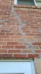 Foundation crack repair and inspection highlighting signs of water damage.