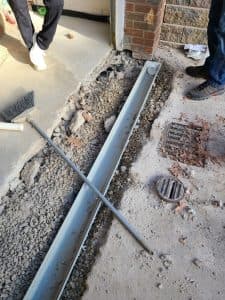 French drain installation and waterproofing drainage solution for block walls.