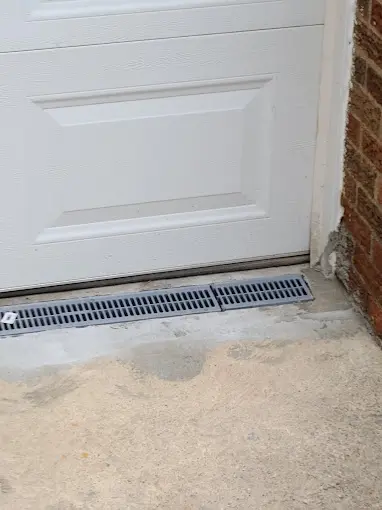 Exterior drainage system and French drain protecting a basement from flooding.