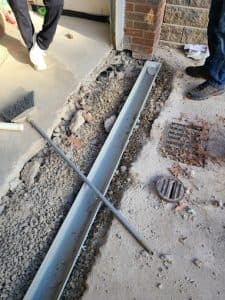 Basement waterproofing drainage system and French drain installation for energy efficiency and potential rebates.