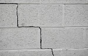 Cracked concrete wall highlighting foundation issues relevant to home inspections and repair considerations.