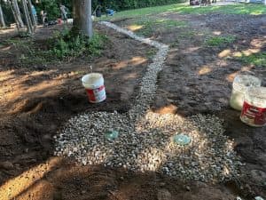 Installed interior drain tile system with gravel and footing protection.