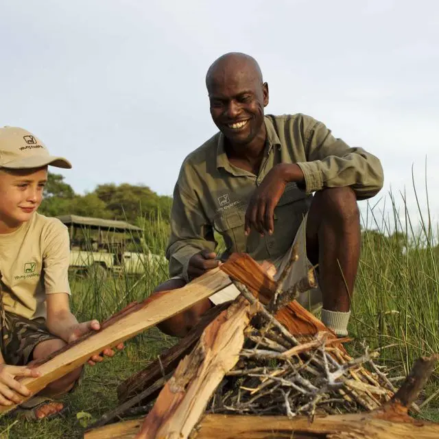 kid learning to build a fire at footsteps