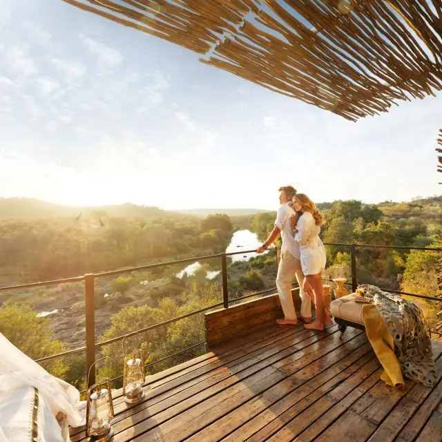 couple relaxing and looking out at animals