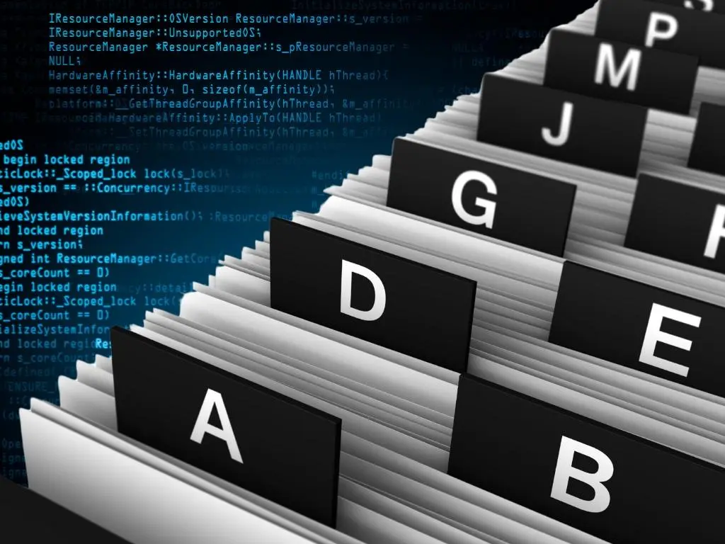 Alphabetical file organizer with code in background, representing top online directory listings for landscaping businesses