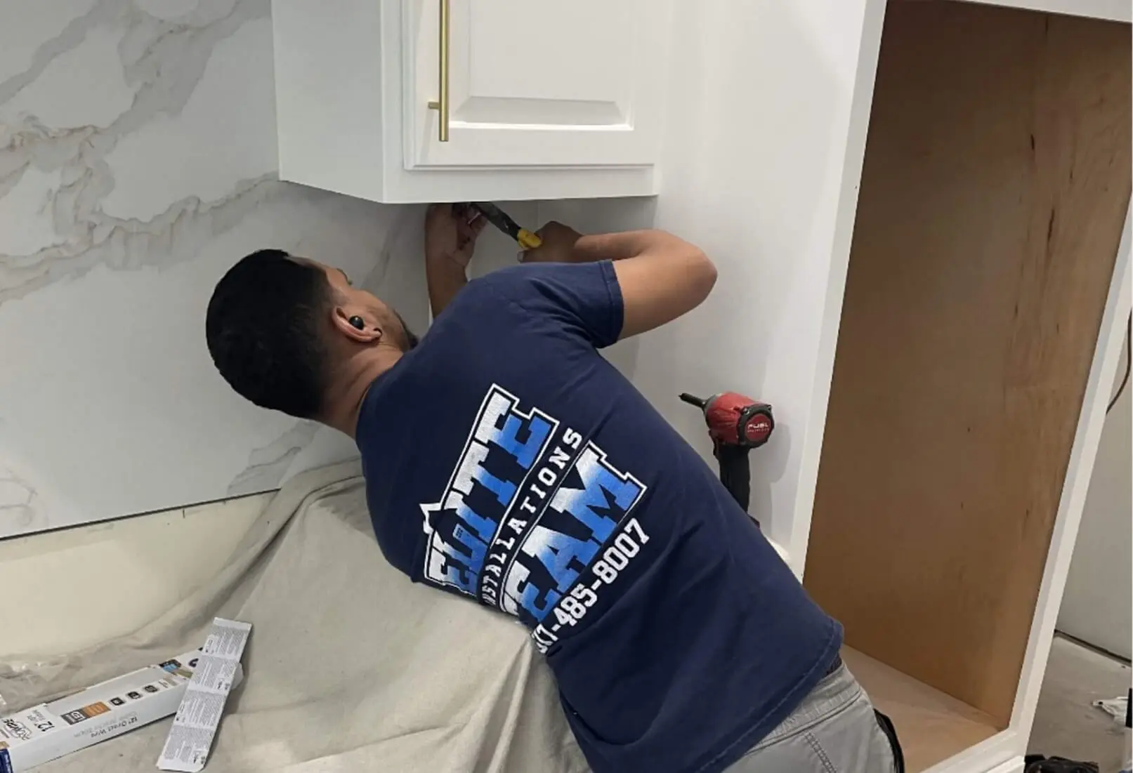 a man working on a cabinet