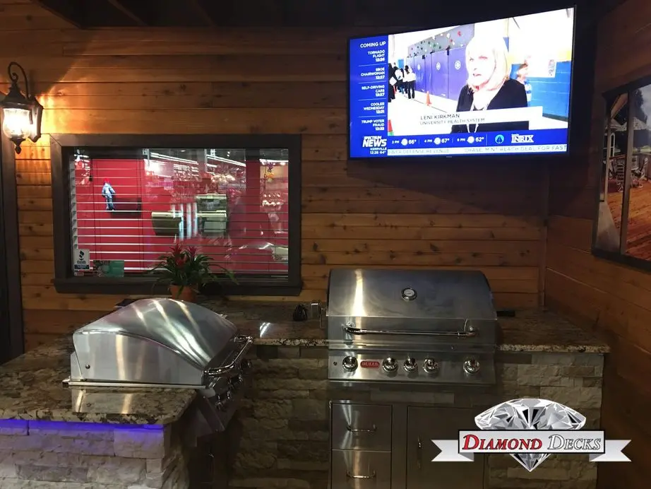 Stacked stone kitchen with Bull grill, griddle and TV by Diamond Decks in San Antonio, TX