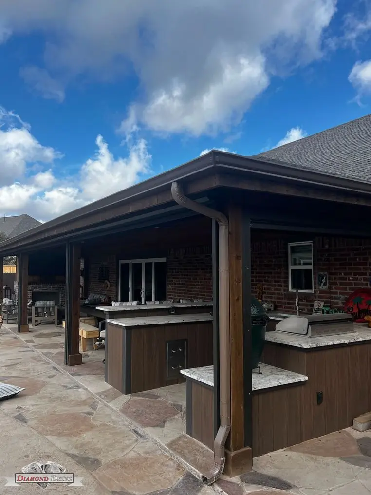 Attached patio cover over an outdoor kitchen by Diamond Decks, San Antonio, TX