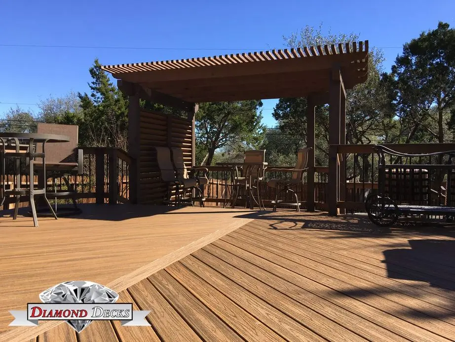 Composite deck with stained pergola and louvered privacy screen by Diamond Decks, San Antonio TX