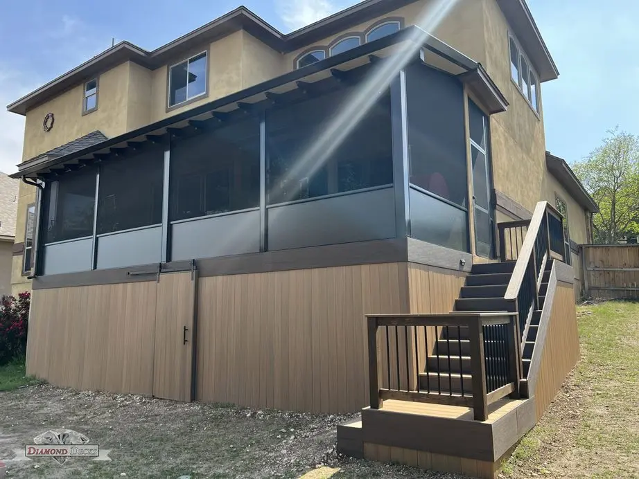 Two-story screened porch enclosure with composite deck stairs by Diamond Decks