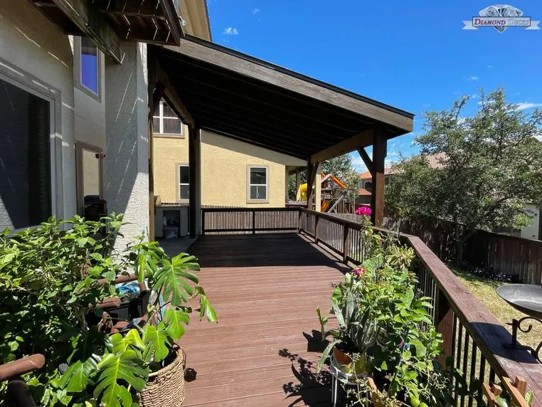Wood patio cover over a backyard deck by Diamond Decks, San Antonio, TX