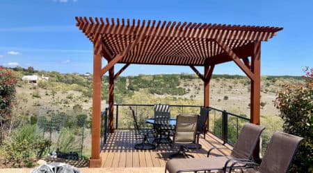 Freestanding stained pergola on composite deck with hill country views by Diamond Decks, San Antonio TX