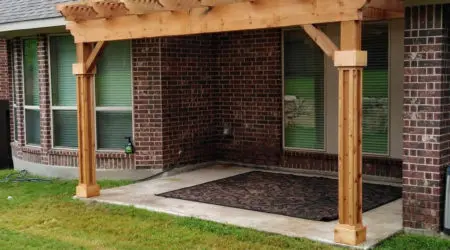 Attached cedar pergola with wrapped posts on a brick home by Diamond Decks, San Antonio TX
