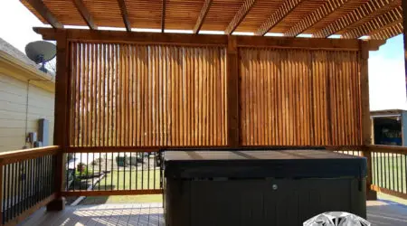Cedar pergola with vertical slat privacy walls around hot tub by Diamond Decks, San Antonio TX