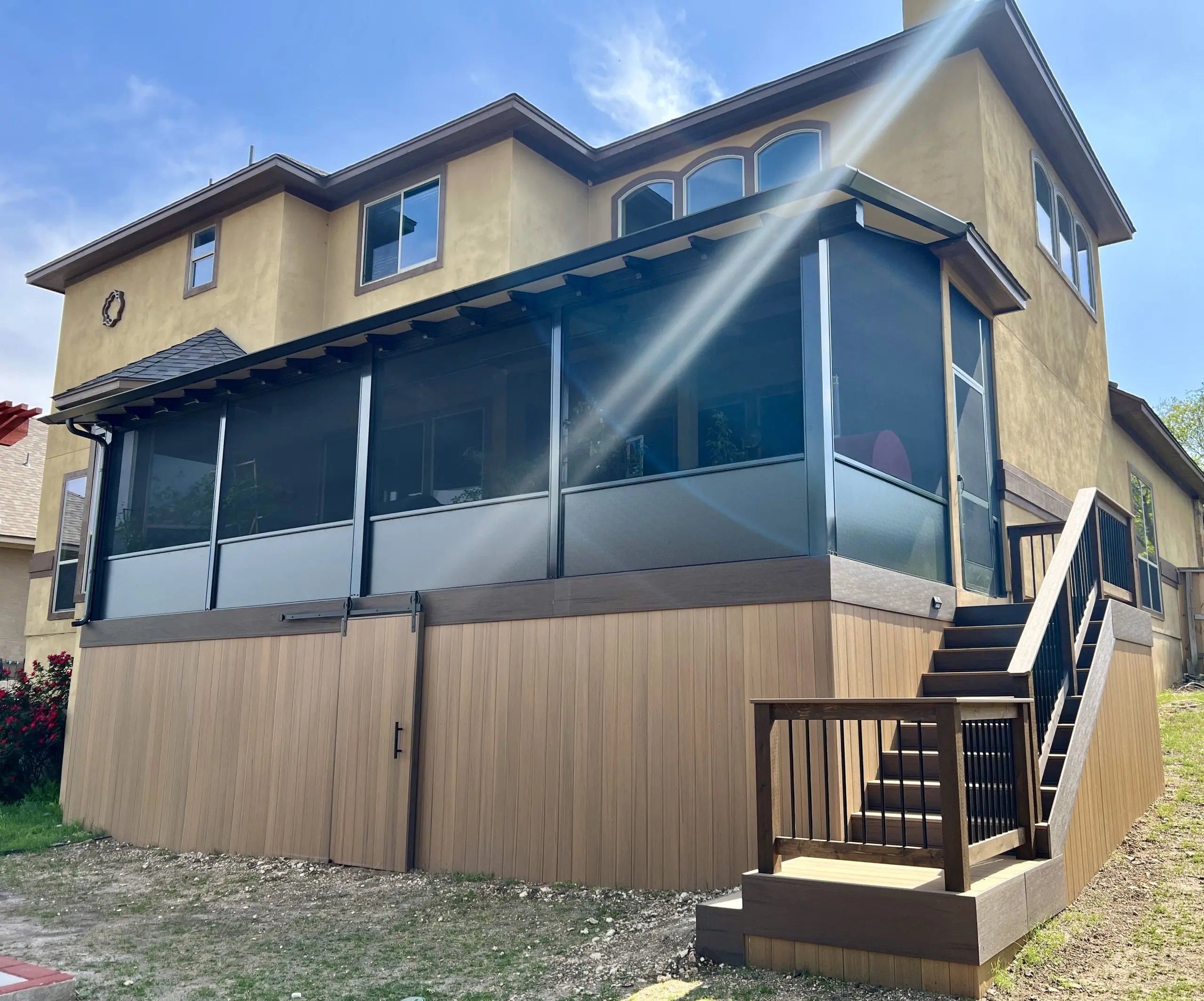 Screened porch enclosure with composite skirting and stairs by Diamond Decks