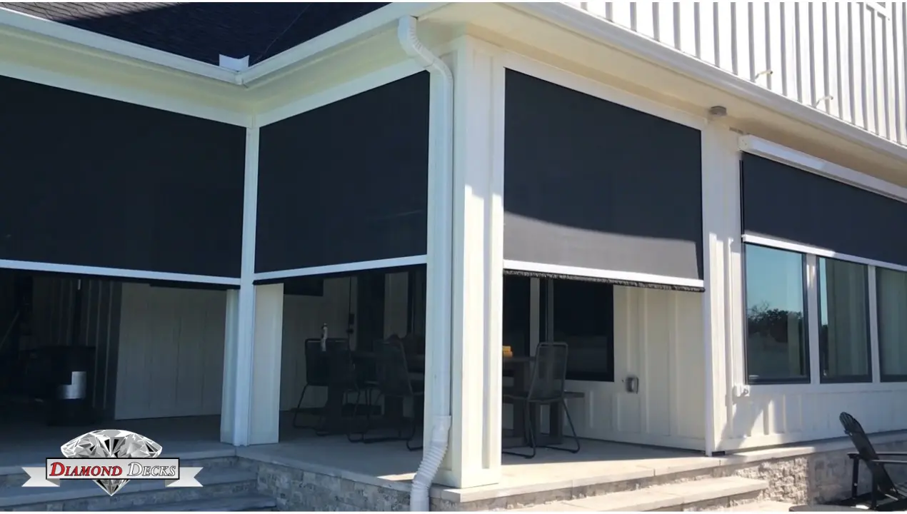 Motorized retractable screen shades enclosing a covered patio by Diamond Decks