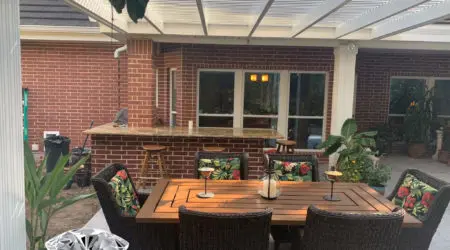 White louvered patio cover over brick bar and dining set by Diamond Decks, San Antonio TX