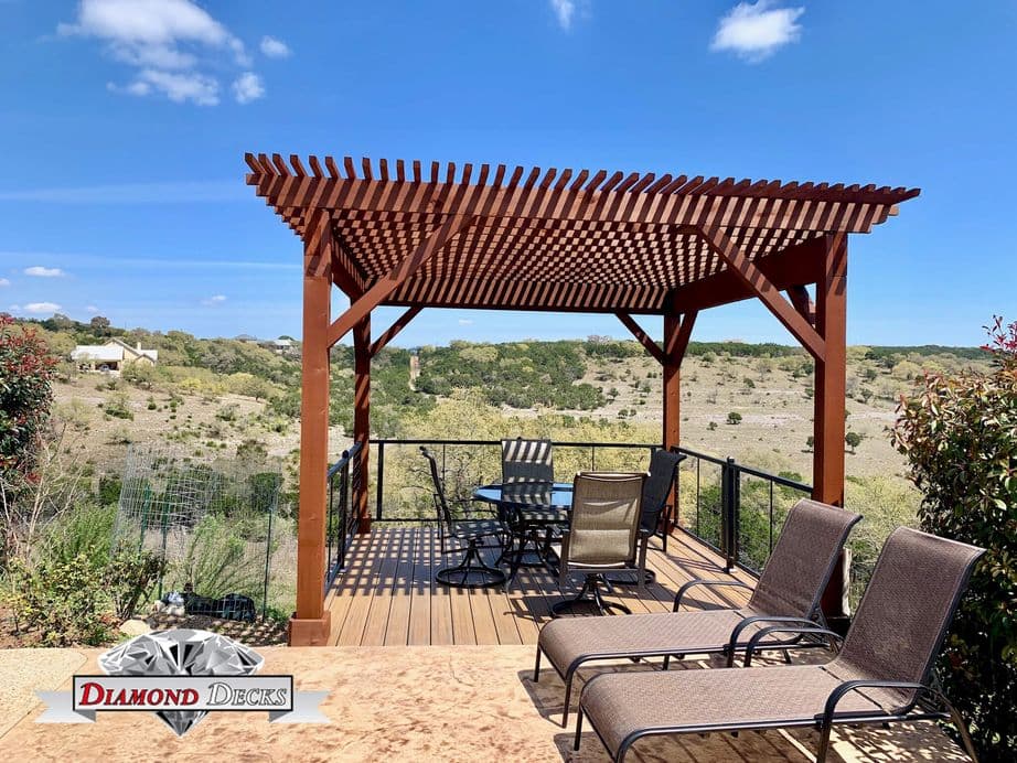 Freestanding stained pergola on composite deck with hill country views by Diamond Decks, San Antonio TX