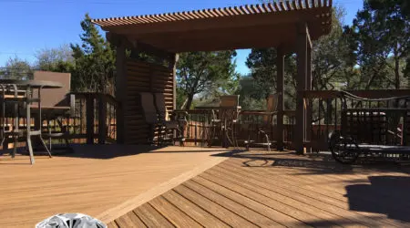 Composite deck with stained pergola and louvered privacy screen by Diamond Decks, San Antonio TX