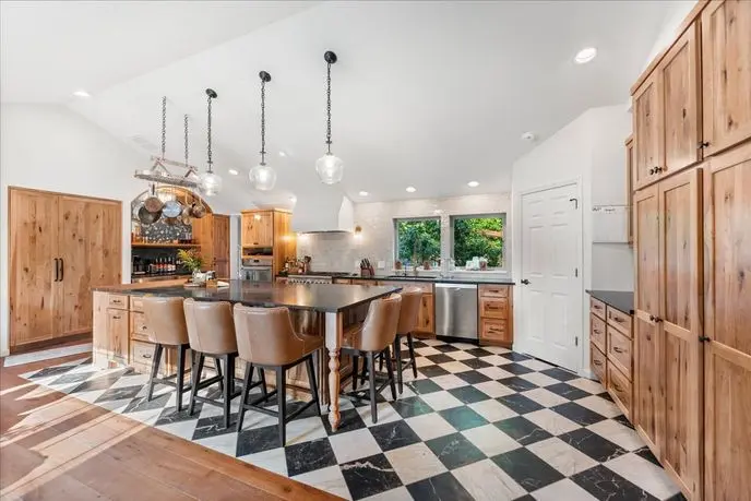 Sammamish farmhouse kitchen remodel with hickory cabinets, soapstone island and copper pot rack