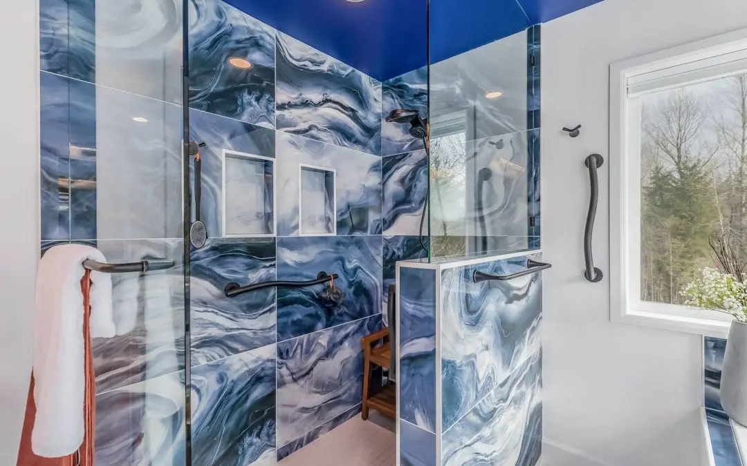Walk-in shower with bold blue swirl tile, navy ceiling and black grab bars in a Sammamish, WA bathroom remodel.