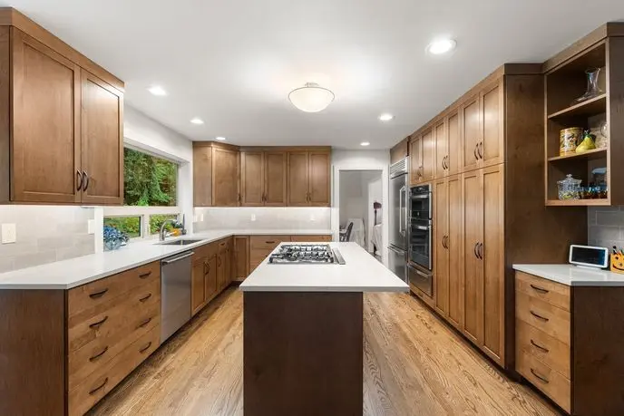 Woodinville kitchen remodel with warm wood shaker cabinets, white quartz island and oak floors