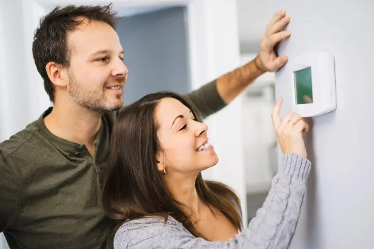 A couple set the thermostat at home