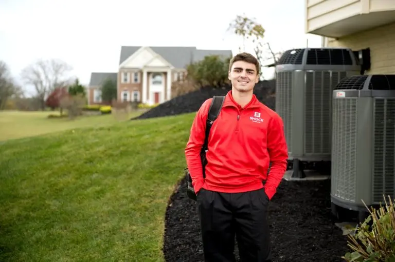 smock worker standing in front of residential house