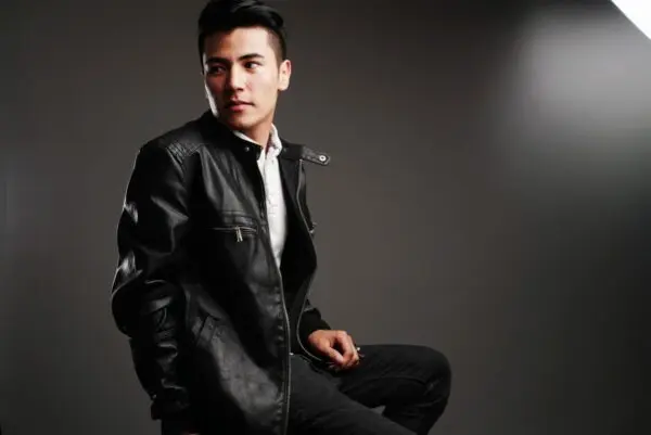 Adult boy wearing black leather jacket
