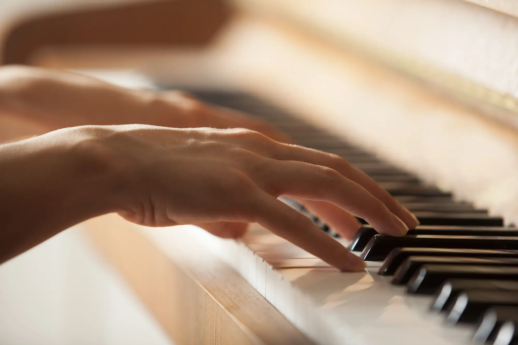 woman hands playing piano