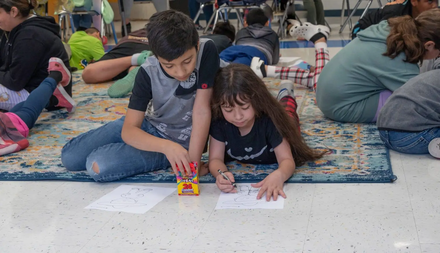 Two children coloring together