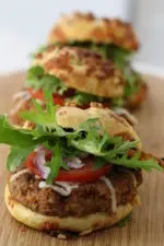 Pecan sliders dressed up and served on a wooden platter. These sliders play into several food trends in 2021.