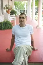 Chef Hugh Acheson sits on a porch.