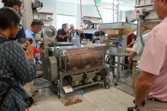 Group takes a look at a 14'' sheller in action at the I‑STEM Research Building at the University of Georgia. (Photo credits from the University of Georgia College of Engineering.)