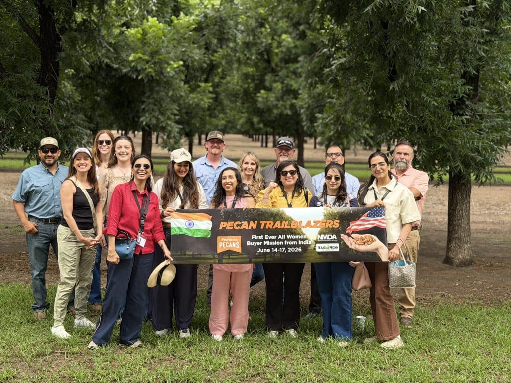 The trade mission literally stopped traffic as the group posed along the often photographed tree lined New Mexico Highway 28 in front of Stahmann Farms. (Image provided by Blair Krebs)