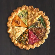 A picture of the Pecan ThanksEverything Pie, which features every dish of the holiday meal in a single pie, with each dish including pecans.