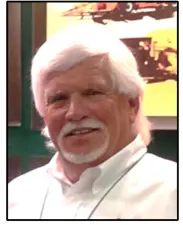A photo of an older white man with white hair and a white goatee.