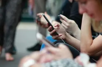 People sit and stare at their phones.