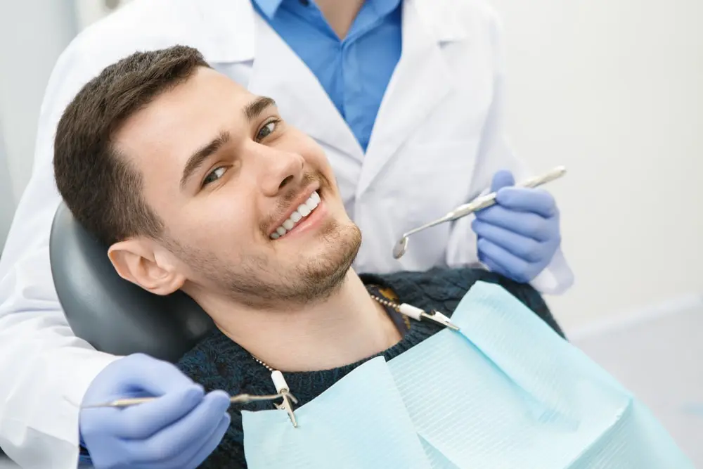 Man smiling at the dentist ready for his dental bonding treatment