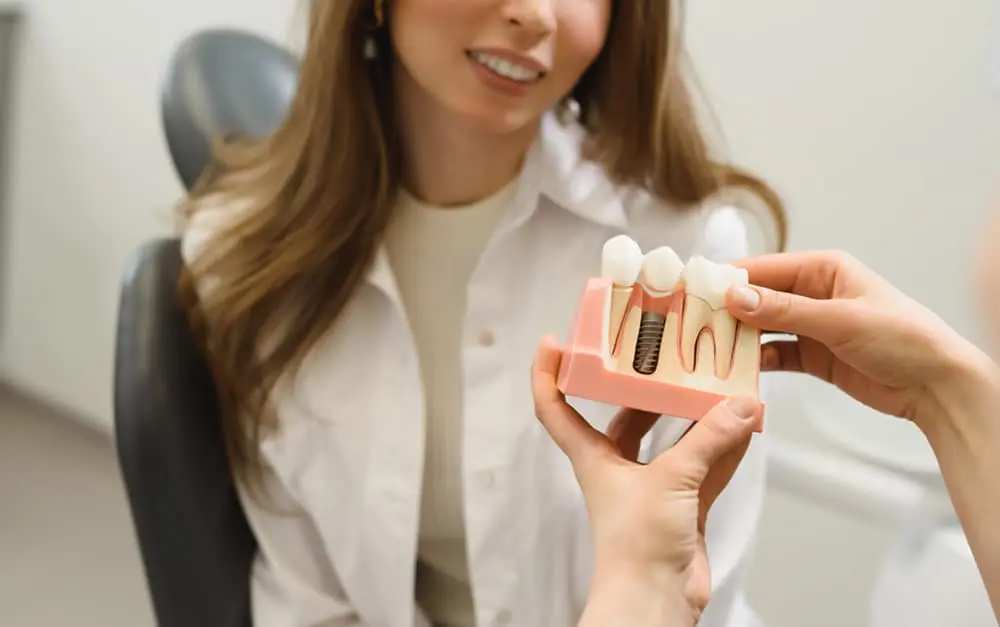 Woman at the dentist discussing dental implants in Brownsville, TX